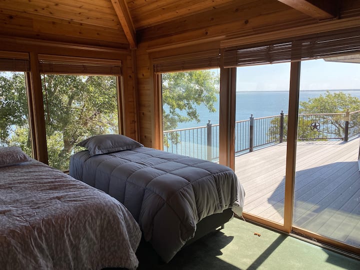 This beautiful bedroom is surrounded by windows with breathtaking views of the lake.  It adjoins the master bedroom and shares the master bathroom. It has 3 XL twin beds.