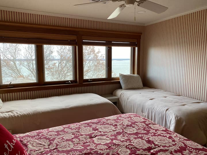This lovely bedroom is upstairs and has a wonderful view of the lake.  It has one queen and 2 XL twin beds. There is a full bathroom inside this room.