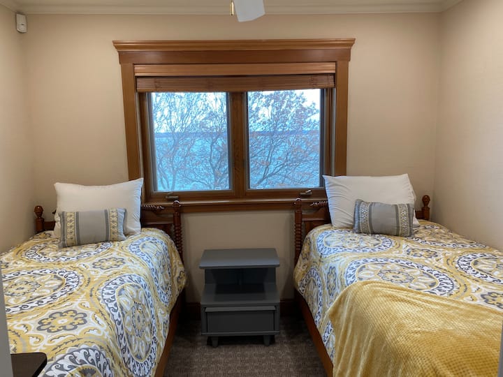 This charming bedroom is upstairs and has a wonderful view of the lake.  It has 2 twin beds and shares a bathroom with one of the two bedrooms upstairs.