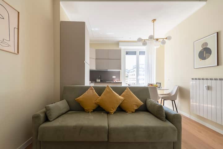 غرفة معيشة مصممة مع طاولة تتسع لـ 4 أشخاص وسرير أريكة وتلفزيون ذكي وتكييف هواء وواي فاي سريع للغاية
