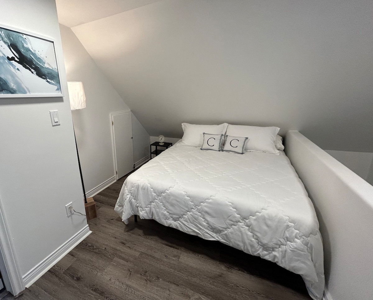 Enjoy a peaceful night's sleep in our cozy loft area featuring a comfortable queen-sized bed.