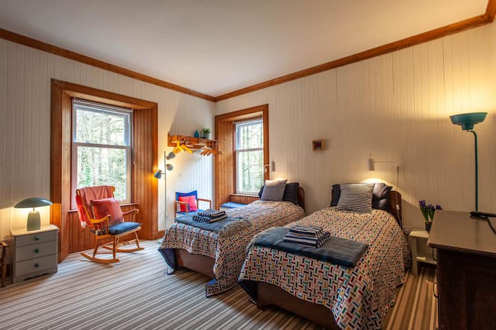 The River Room - twin beds and bunks with a double river aspect. One side looks towards the gorge and cascade - the other overlooks the shallower river bed often frequented by our hungry Herons.