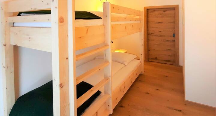 vomLandl Naturloft ZirbenWald.
Habitación 3 con litera de pino macizo (2 x 90 x 200 cm) con acceso al jardín. Materiales naturales, techo de madera de abeto, troncos de pino, ropa de cama natural y suelos de madera de roble.
Perfecto para niños y jóvenes de corazón.