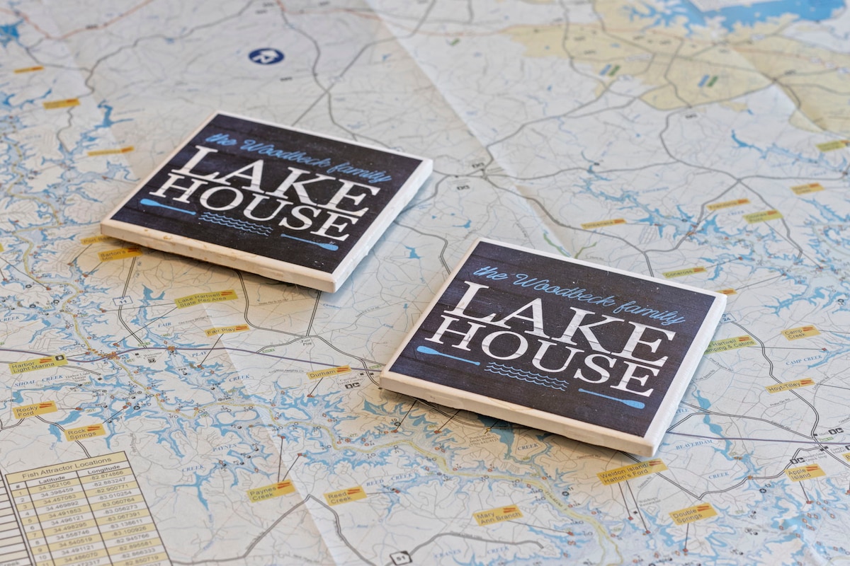 Two coasters with a personalized design are placed on a detailed map of the lake area. The map displays various waterways and terrain features, inviting exploration and adventure in the surroundings.