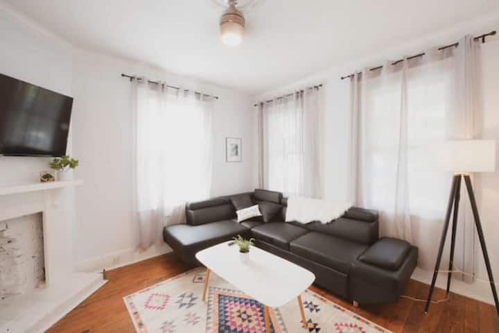 This living room features a cozy sofa and wall mounted flat screen smart TV. Perfect for spending an evening in with a favorite movie.