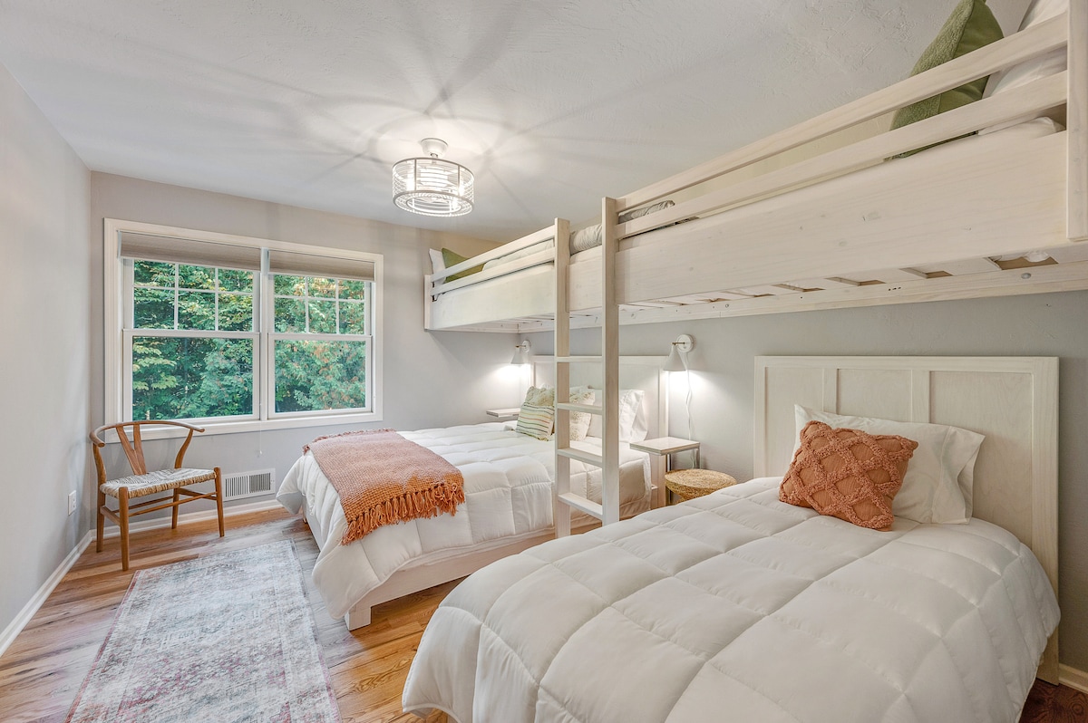 Second floor bedroom with custom made bunk beds including Queen bed, three Twin beds and blackout blinds, smart TV