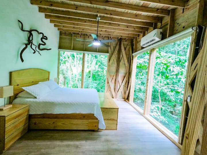 Master Bedroom with an almost panoramic view of the surrounding forest.