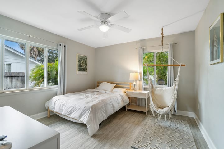 Bedroom 3 is equipped with a queen size bed, black out curtains, nightstand, dresser, and cozy hanging hammock chair
