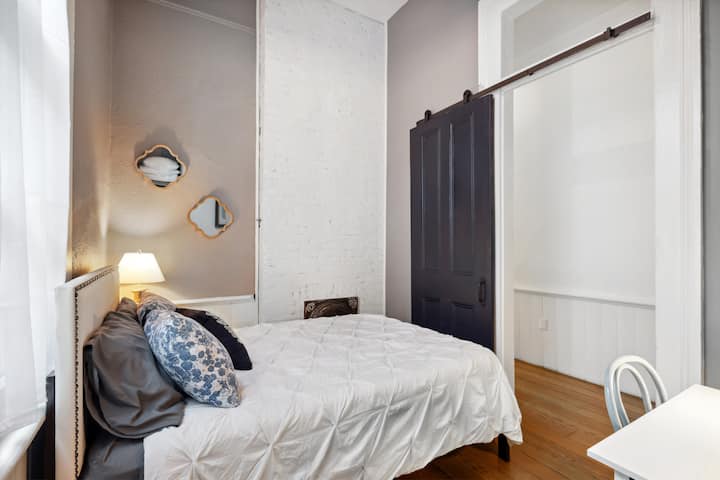 Secondary bedroom with queen bed and dedicated workspace. Unlike a traditional "shotgun" home, our place was renovated to be more private - no walking through one room to get to another.