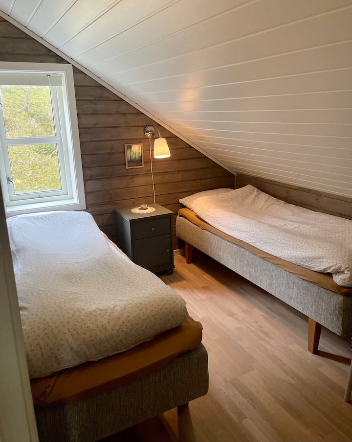 Bedroom with two single beds and a cot