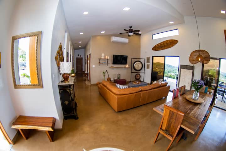 Open concept living and dining area.  75 " TV. Very spacious and comfortable with Italian Leather Designer Couch.