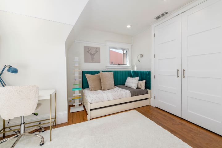 - Perfect nook for kids or solo travelers featuring a stylish bed with a velvet touch
- Study, relax, or stream by the desk with a pop of color and cozy lighting
- Crisp white tones and playful accents make this room feel fresh and fun