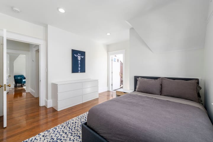 - Rest easy in this peaceful space featuring a comfy bed and clean, modern decor
- Plenty of room to unpack and settle in, with a spacious dresser and natural light
- Calm retreat just steps from other rooms, perfect for families or groups
