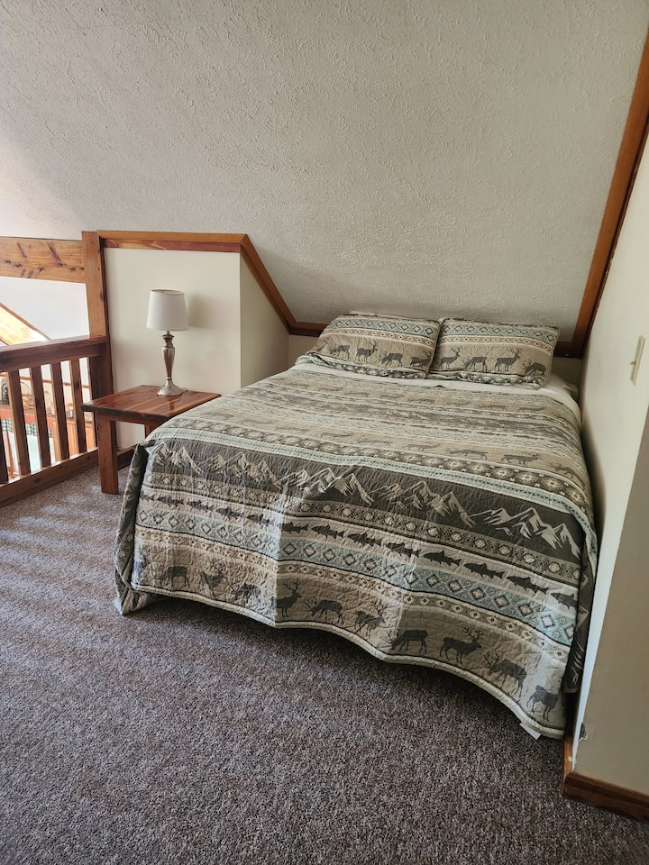 Cama tamaño queen en el área de loft