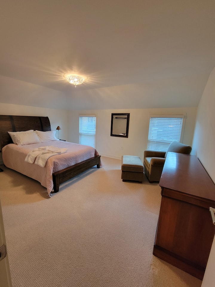 Private spacious bedroom to relax and recharge has a king size bed.