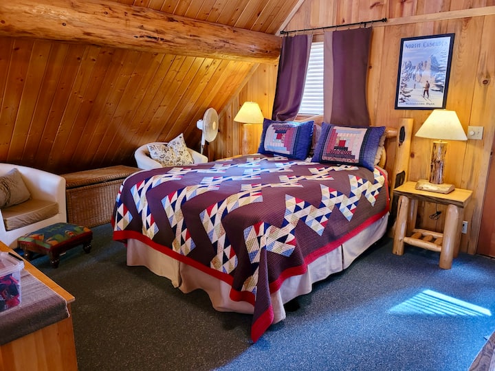The upstairs loft acts as a second bedroom with a queen bed, two twin beds, and access to the balcony. 