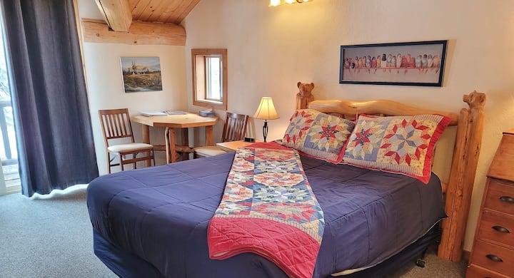 Queen bed in the upstairs bedroom.