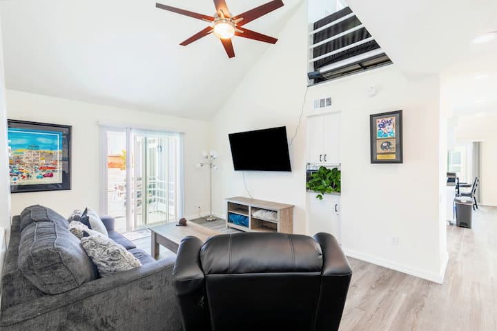 Comfy living room with queen sofa bed + recliner. An abundance of windows and sliding glass door to the balcony provides nice ocean cross breeze.  A big remote controlled ceiling fan.  65" Fire TV with Hulu, Netflix, Sling, Etc.  Local channels too