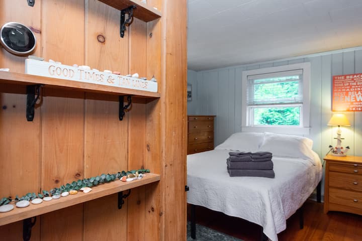 Bedroom 1 view from hallway,  TV, premium streaming & DIRECTTV provided, closet, bureau, nightstand, clean linens. 