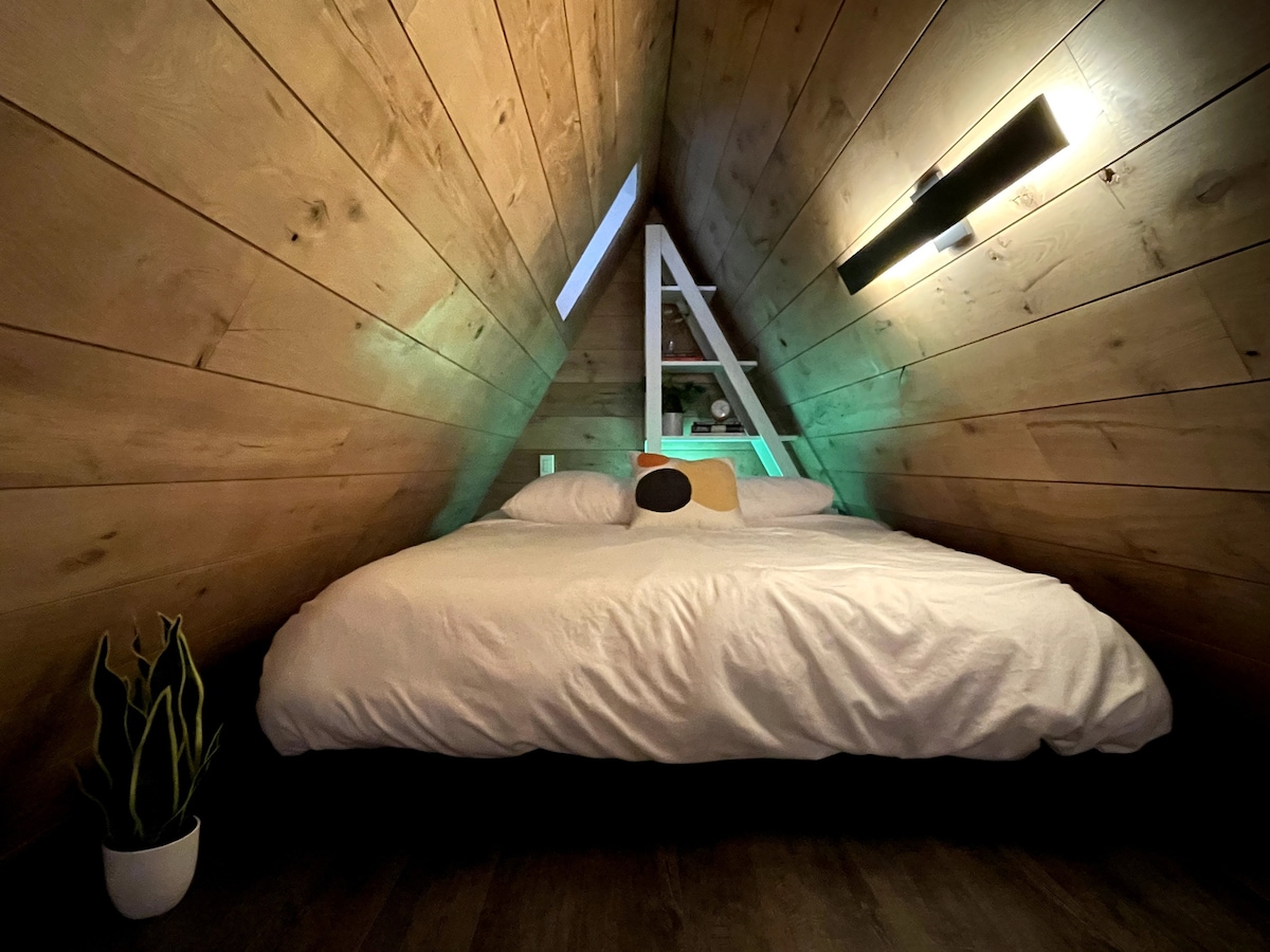 Casper queen sized bed in the open loft which includes a sky light  - accessed by ladder 