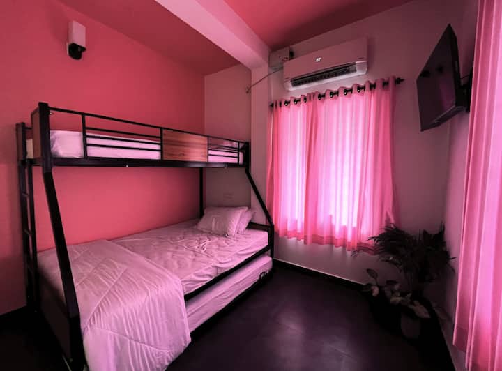 Unleash your inner child in this vibrant pink room on the ground floor! Snuggle up in the bunk beds and let your imagination run wild...