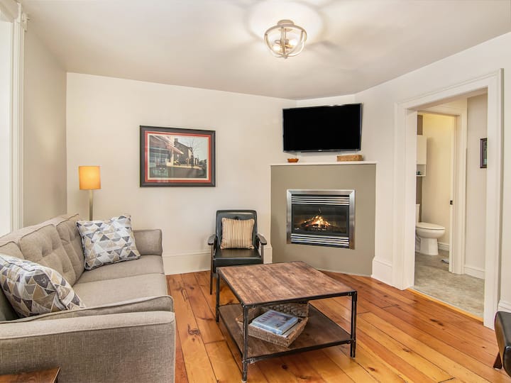 Livingroom features new queen pull out couch, fireplace and television with Roku guest access. 