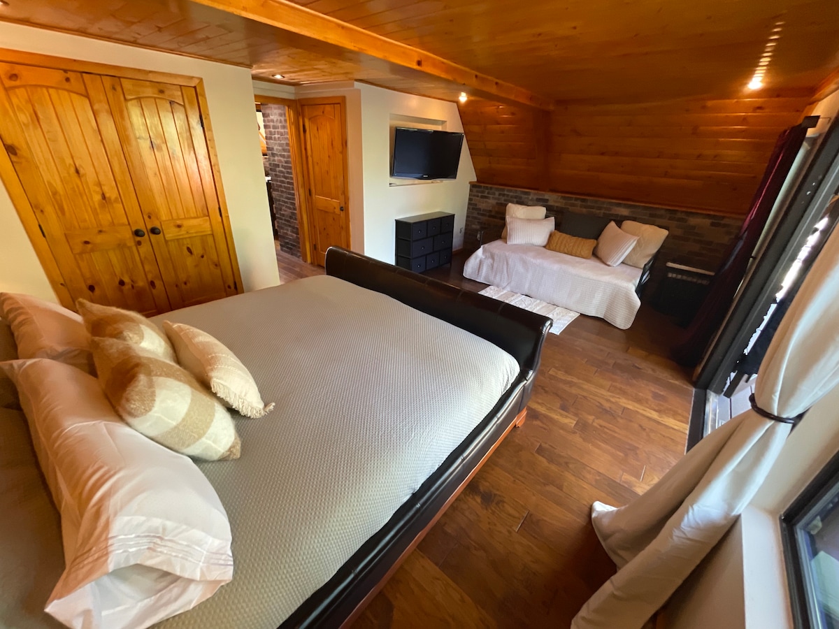 Large and spacious first floor bedroom provides excellent access to living room, kitchen, two decks, laundry, and bathroom. 