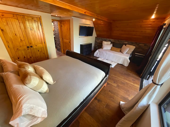 Large and spacious first floor bedroom provides excellent access to living room, kitchen, two decks, laundry, and bathroom. 