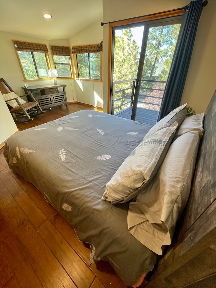 Spacious second floor guest room with sitting area and balcony. It's like your own personal tree house!