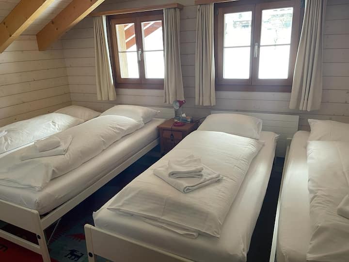 Bedroom 4 with all four single beds made up. The two beds in the middle fit underneath the other two if not being used. 