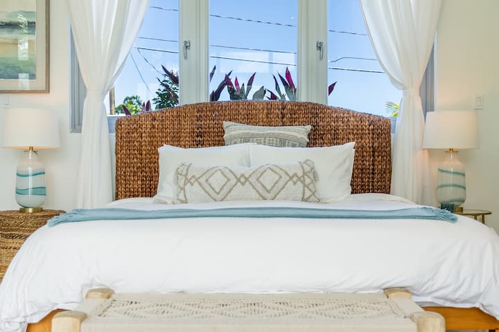 Enjoy a good night's rest on this king-size bed in the Principal Suite. 