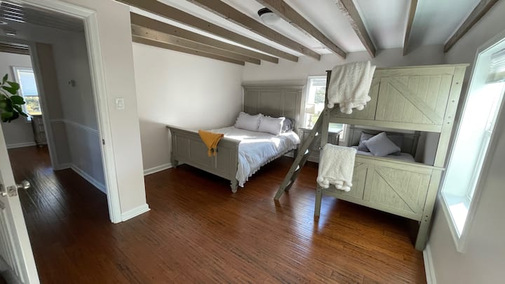 This upstairs bedroom has a queen bed with a memory foam mattress with new pillows, a bunk bed (two twin mattresses, new pillows), and a walk-in closet.