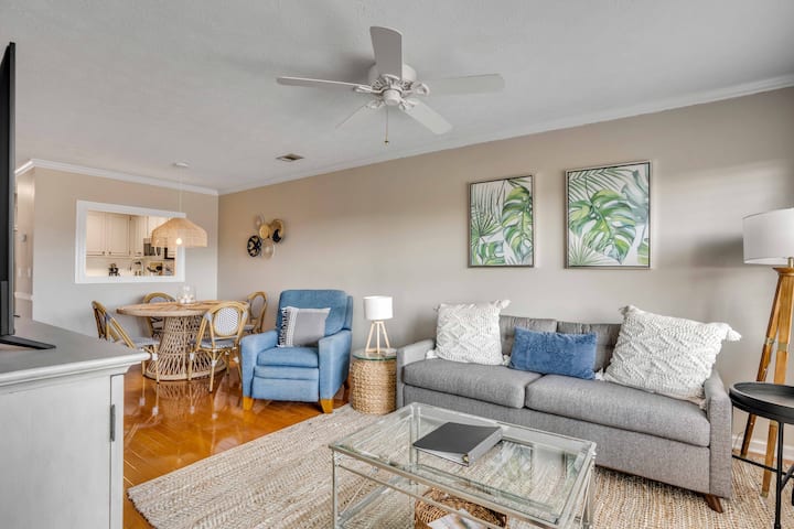 Relax in the bright open-concept living room featuring a pull-out sofa  and seamless connectivity with the kitchen and dining area.  A smart tv with hookup is provided for streaming your service or watching your device.  (cable is not provided).
