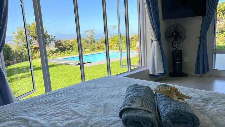 Гледка към градината, басейна, морето и планината от спалнята за гости