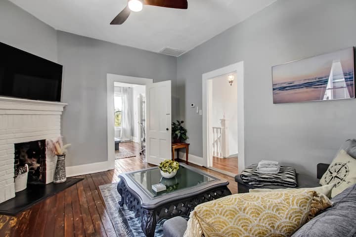 2nd Floor - At the top of the stairs, is the cozy living room, with a decorative brick fireplace feature, large flat screen Roku smart TV, and a sofa that pulls out to a queen size sleeper that can accommodate 2 additional guests.