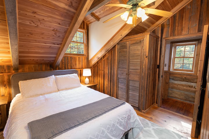 Master bedroom with queen bed has private bathroom with shower. Upholstered headboard has USB port for convenient charging of devices.