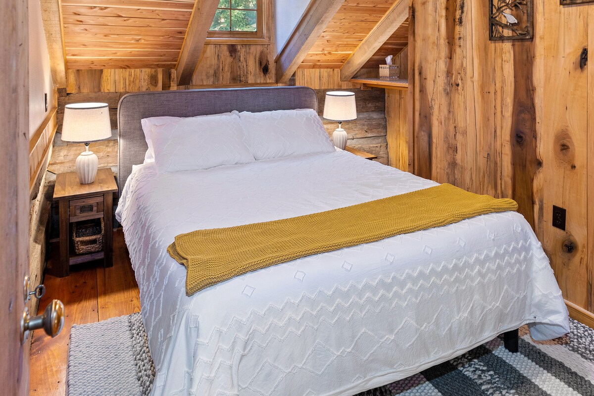 Guest bedroom with queen bed upstairs has access to full bath on downstairs level.