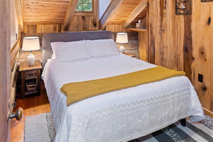 Guest bedroom with queen bed upstairs has access to full bath on downstairs level.