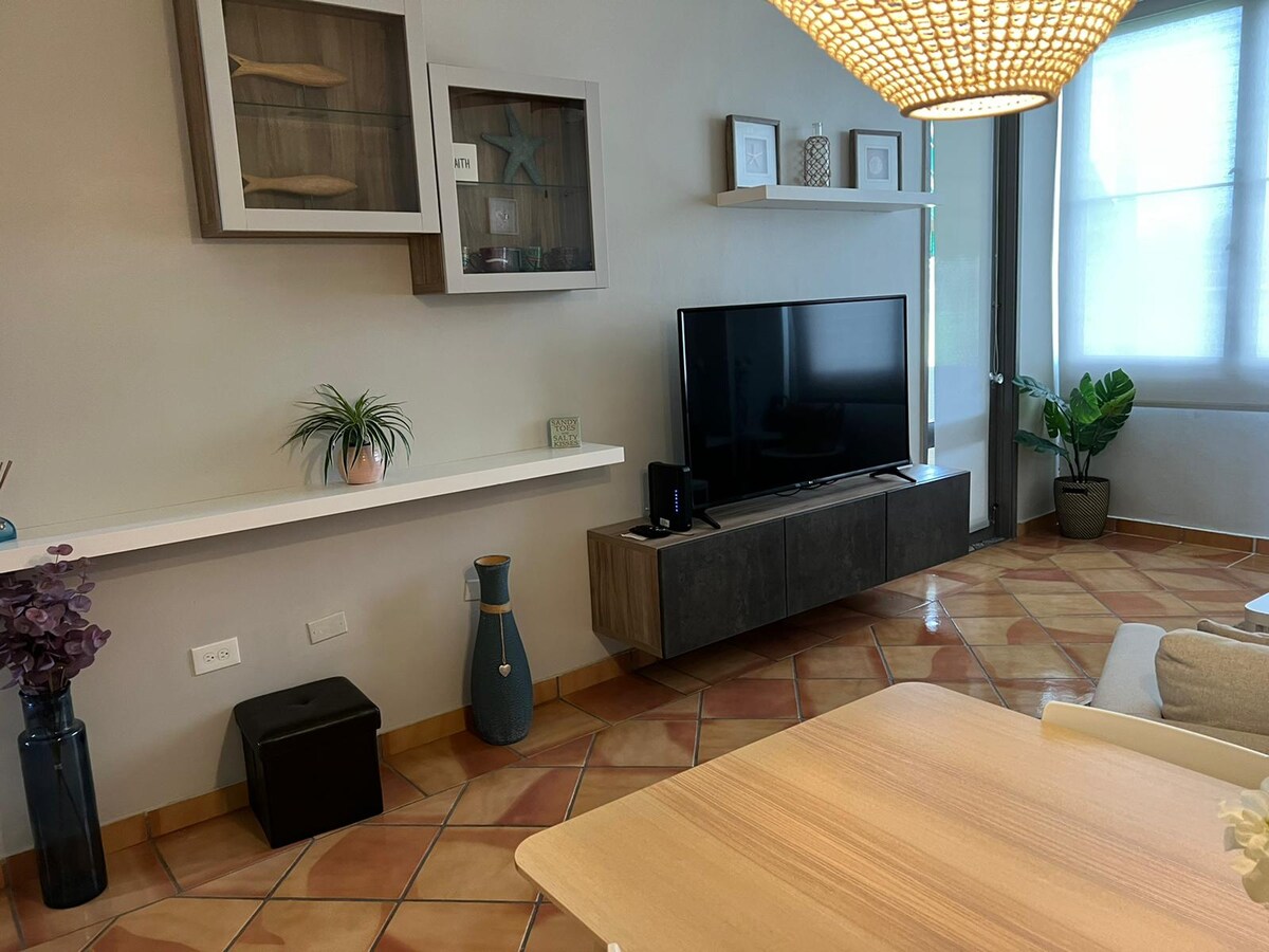 Livingroom TV and access door to balcony.