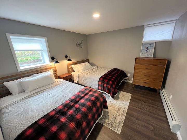 Guest bedroom on lower level with two queens beds.
