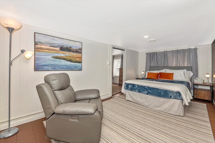 Dormitorio con cama tamaño queen. La puerta a la izquierda de la cama conduce al espacio de oficina dedicado.