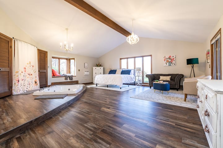 Master bedroom with king size bed, large soaker tub, walk in shower and cozy sitting area.  