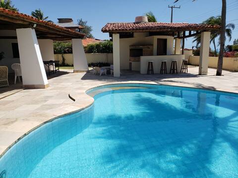Beach house with pool and beach tennis court.
