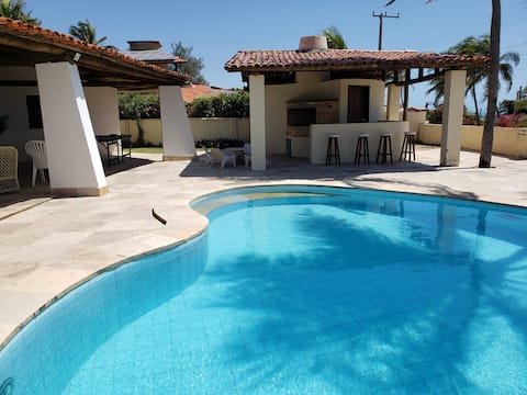 Beach house with pool and beach tennis court.