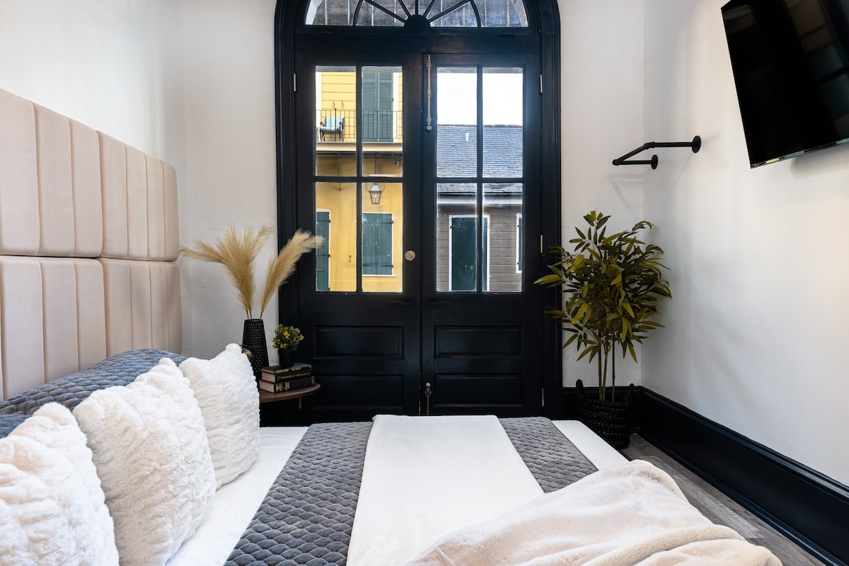 Second bedroom with French doors that open onto Saint Philip Street, a true French Quarter experience. 