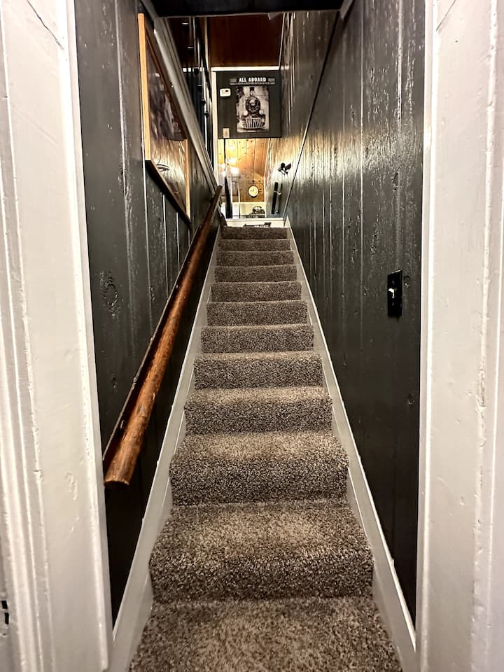 This is the stairway leading to the 2 bedrooms upstairs. It has a handrail on the left.