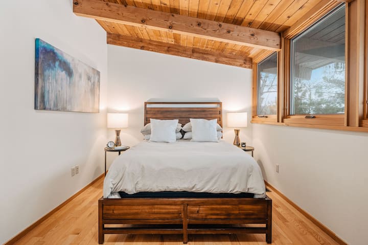 Bedroom with queen bed and workspace