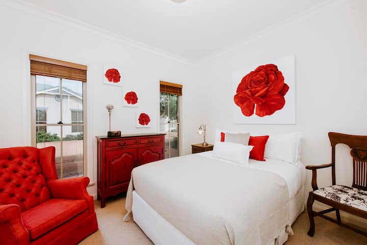 Druhá spálňa kombinuje zdobený nábytok s výraznými farebnými prvkami, aby vytvorila príjemné privítanie.
