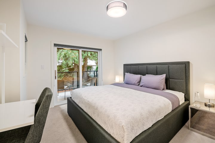 Bedroom 2: Located on the ground floor and set back. The room has a stylish king bed, office space with a desk, and an ensuite bathroom with a shower and bathtub. Access to the hot tub is via the patio doors with a seating area.