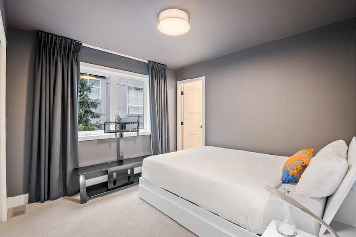 Bedroom 3: Located downstairs with a queen bed and next to bedroom 2. Has an ensuite bathroom with a shower and bathtub.